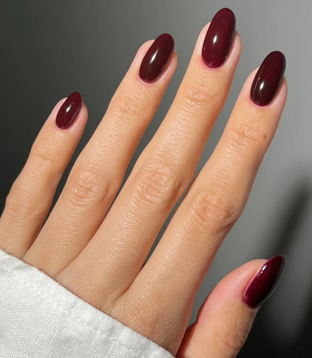 Hand with manicured nails wearing Pink Gellac 112 Chique Red gel polish.
