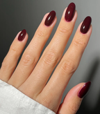 Hand with manicured nails wearing Pink Gellac 112 Chique Red gel polish.
