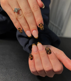 Hands with black manicured nails wearing Pink Gellac 120 Beautiful Black gel polish.