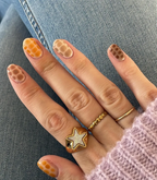 Hand with manicured nails wearing Pink Gellac 203 Chocolate Brown gel polish.