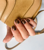 Hand with manicured nails wearing Pink Gellac 203 Chocolate Brown gel polish.