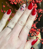 Hand with manicured nails wearing Pink Gellac 235 Ruby Red gel polish.