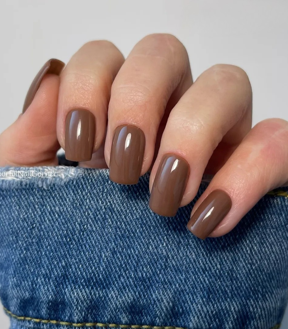 Hand with manicured nails wearing Pink Gellac 259 Hazelnut Brown gel polish.