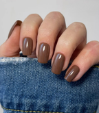 Hand with manicured nails wearing Pink Gellac 259 Hazelnut Brown gel polish.