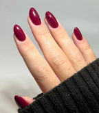 Hand with manicured nails wearing Pink Gellac 307 Maroon Purple gel polish.