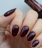 Hand with manicured nails wearing Pink Gellac 308 Dramatic Red gel polish.