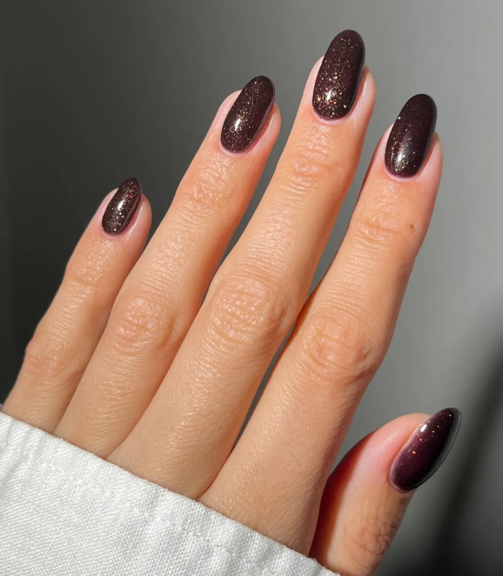 Hand with manicured nails wearing Pink Gellac 333 Oriental Spice gel polish.