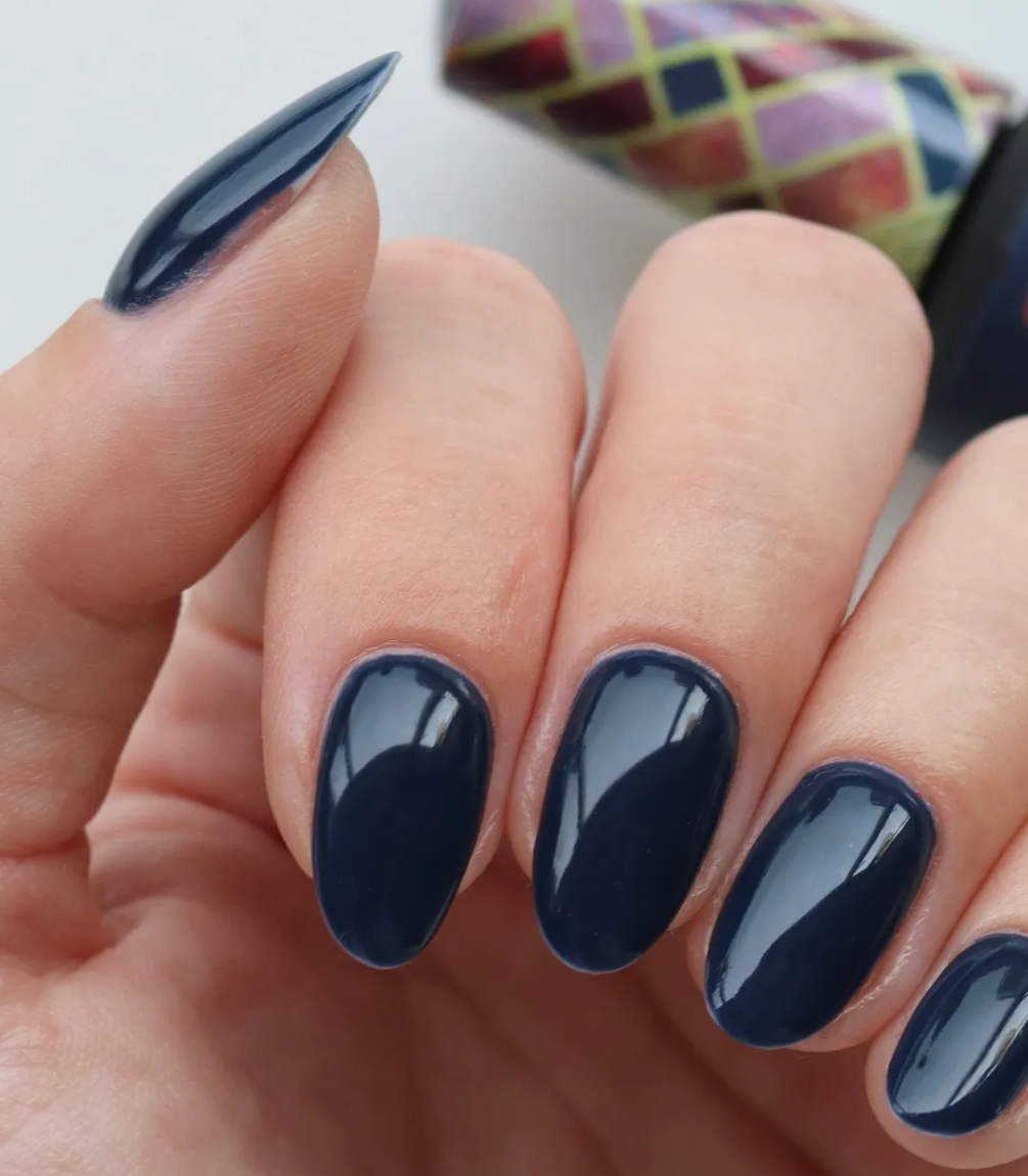 Hand with manicured nails wearing Pink Gellac 338 Classic Blue gel polish.