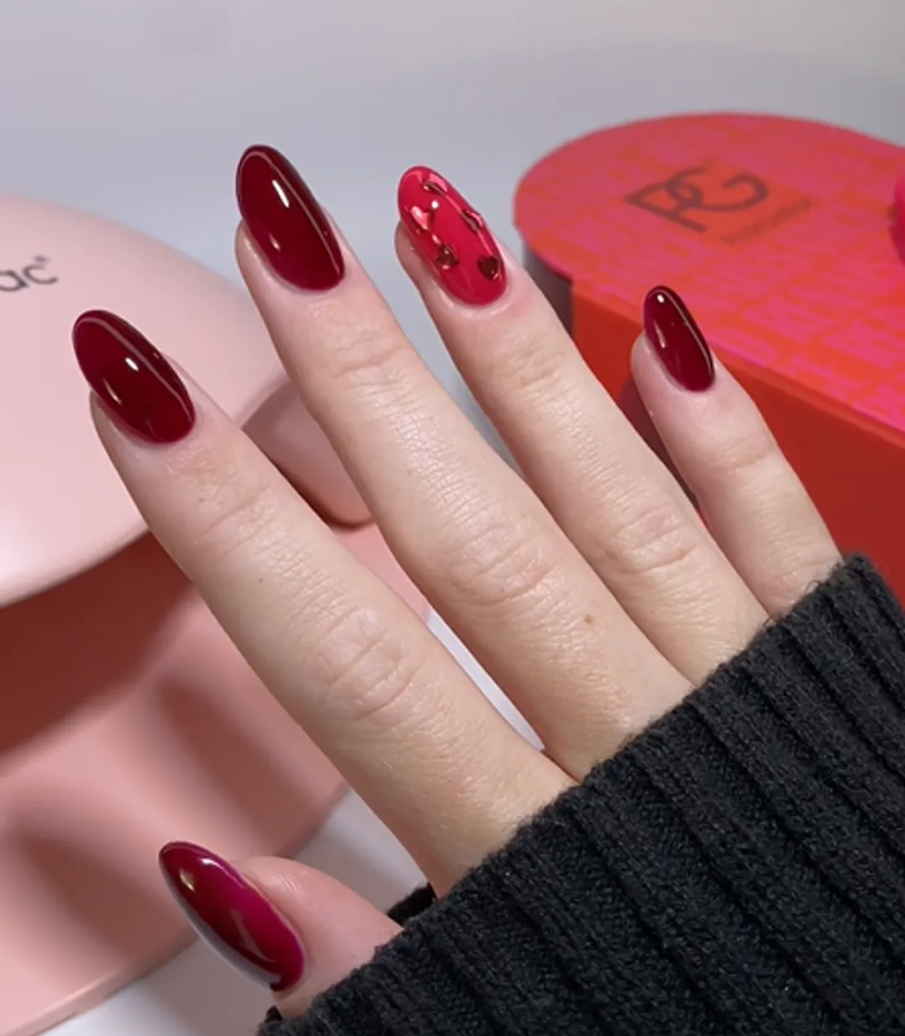 Hand with manicured nails wearing Pink Gellac 439 Berry Sheen gel polish.