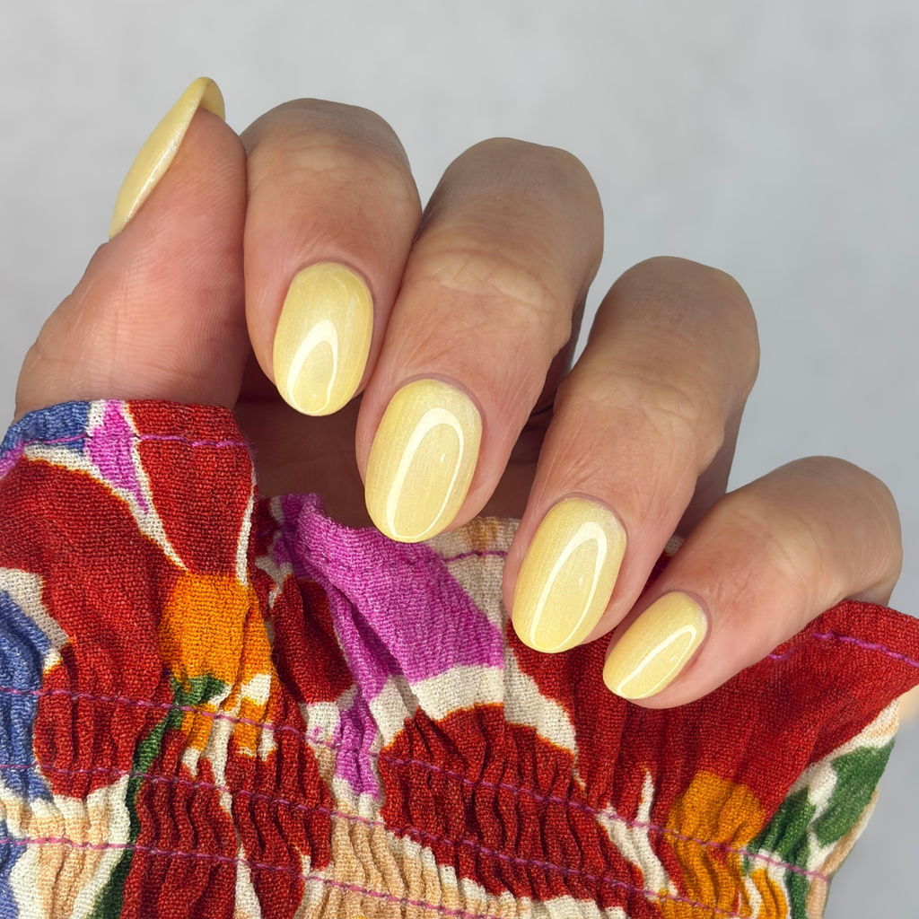 Manicured nails painted with Pink Gellac 487 Yummy Yellow gel polish.