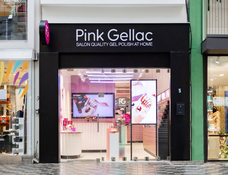 Pink Gellac storefront with illuminated shop window and images of gel nail polish.