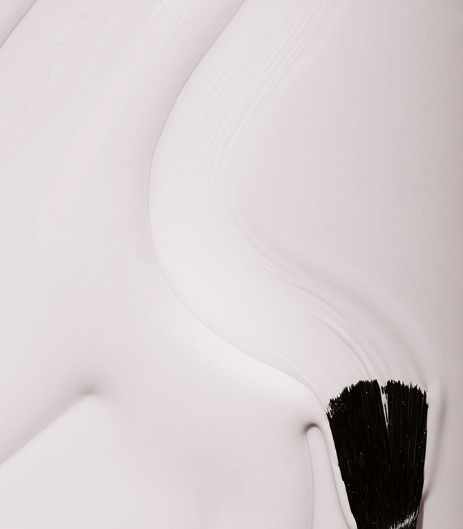 Smear of Pink Gellac 101 Soft White gel polish with a brush, showing the soft white shade.