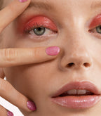 Close-up of a woman with Pink Gellac 243 Diamond Pink manicured nails near her face.