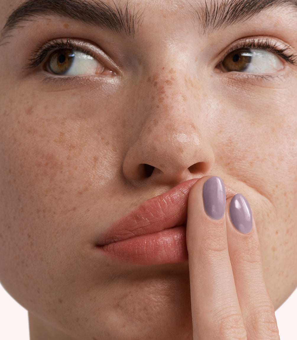 Close-up of a woman with Pink Gellac 278 Moody Mauve manicured nails near her face.