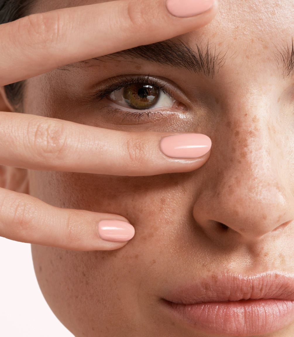 Close-up of a woman with Pink Gellac Rubber Base Cover Playful Pink manicured nails near her face.