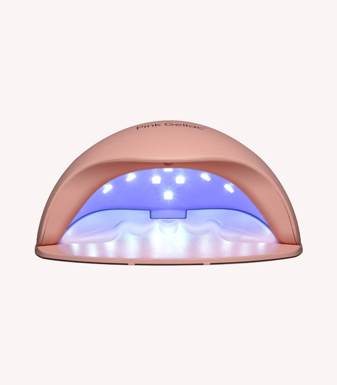 Pink LED nail lamp with white and blue light for curing gel nail polish.