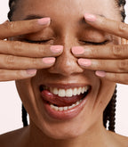 Close-up of a woman with Pink Gellac Build it Base Natural Beige manicured nails near her face.