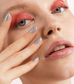 Close-up of a woman with Pink Gellac 129 Fabulous Silver manicured nails near her face.