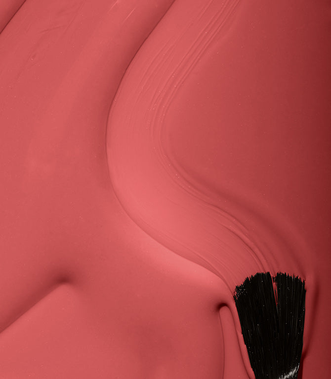 Close-up of Pink Gellac 142 Coral Red gel polish texture.