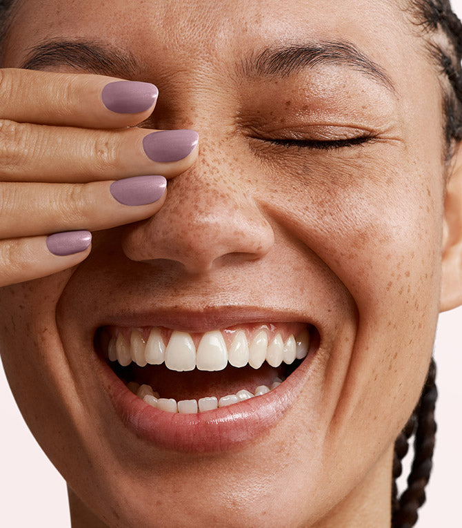 Close-up of a woman with Pink Gellac 152 Naked manicured nails near her face.