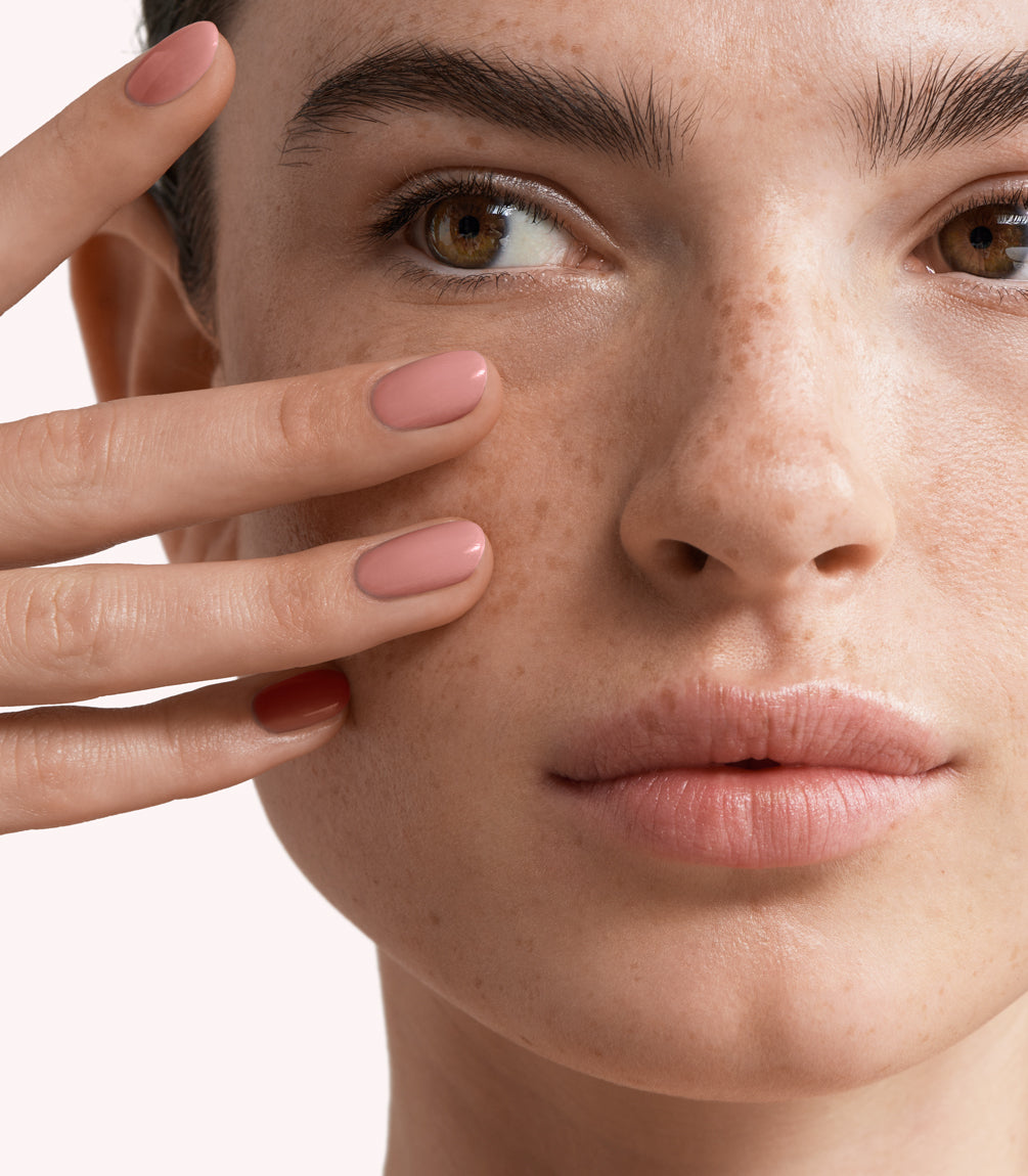 Close-up of a woman with Pink Gellac 166 Vintage Nude manicured nails near her face.
