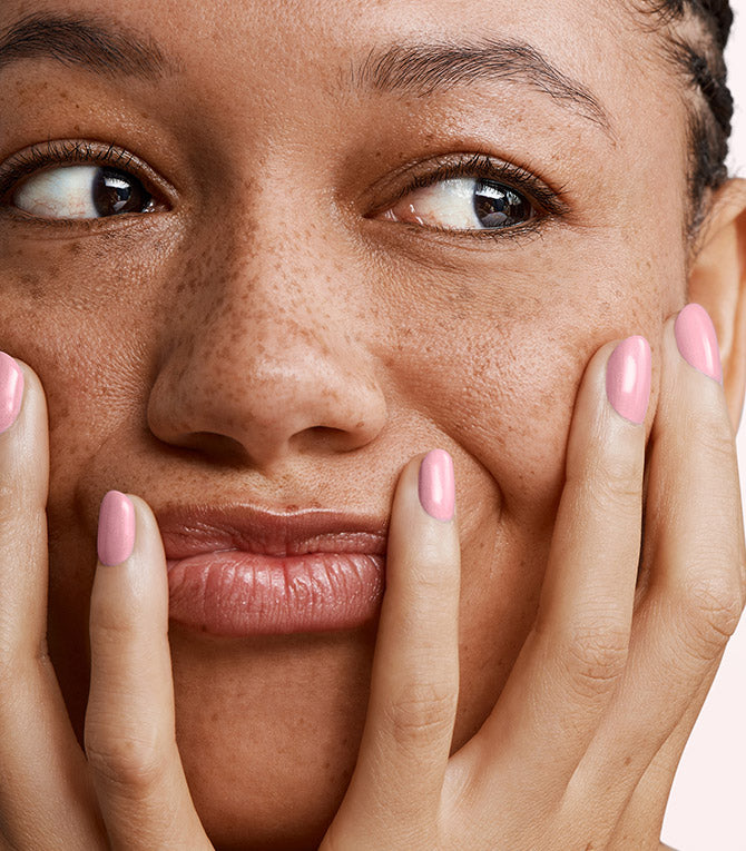 Close-up of a woman with Pink Gellac 179 Lovely Pink manicured nails near her face.
