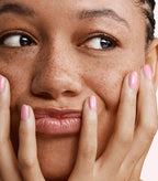 Close-up of a woman with Pink Gellac 179 Lovely Pink manicured nails near her face.