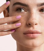 Close-up of a woman with Pink Gellac 184 Rosy Pink manicured nails near her face.