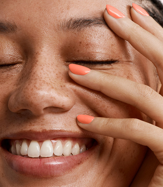 Close-up of a woman with Pink Gellac 214 Cosmopolitan manicured nails near her face.