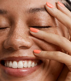 Close-up of a woman with Pink Gellac 214 Cosmopolitan manicured nails near her face.
