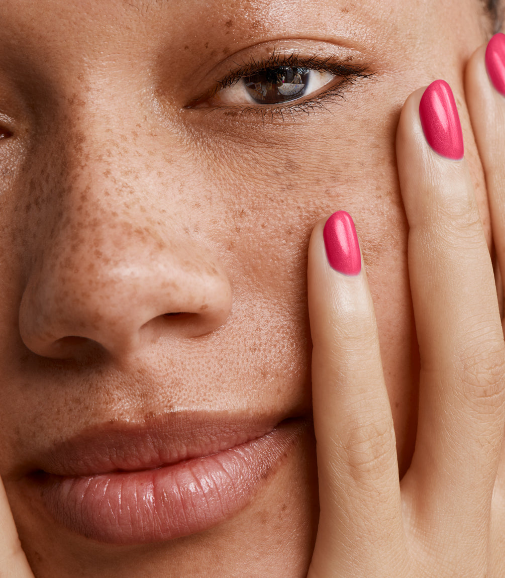 Close-up of a woman with Pink Gellac 222 Amazing Pink manicured nails near her face.