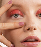 Close-up of a woman with Pink Gellac 246 Mermaid Pink manicured nails near her face.