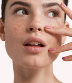 Close-up of a woman with Pink Gellac 251 Nude Pink manicured nails near her face.