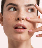 Close-up of a woman with Pink Gellac 265 Milkshake Pink manicured nails near her face.