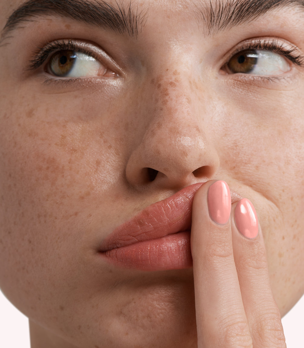Close-up of a woman with Pink Gellac 275 Fresh Pink manicured nails near her face.