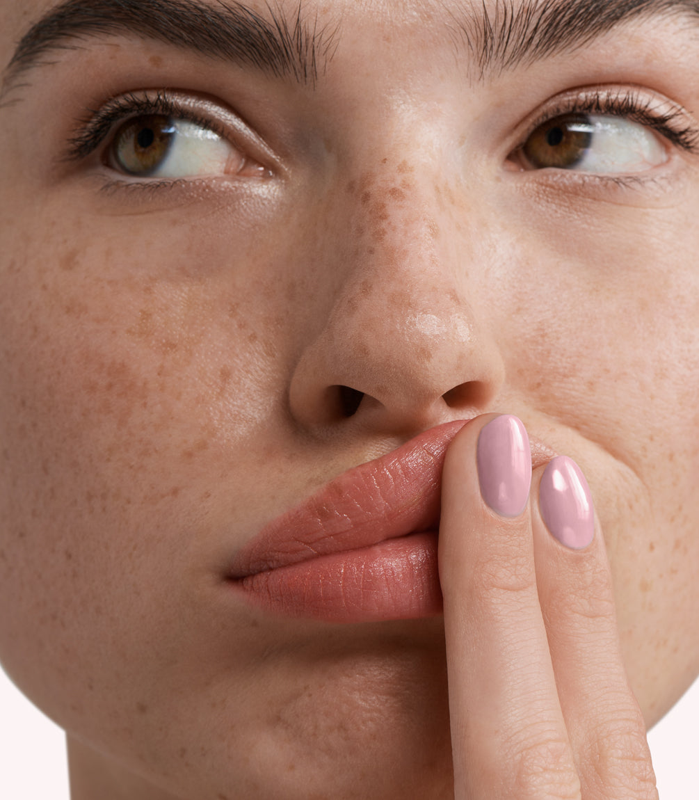 Close-up of a woman with Pink Gellac 276 Powdered Mauve manicured nails near her face.