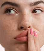 Close-up of a woman with Pink Gellac 285 Happy Pink manicured nails near her face.