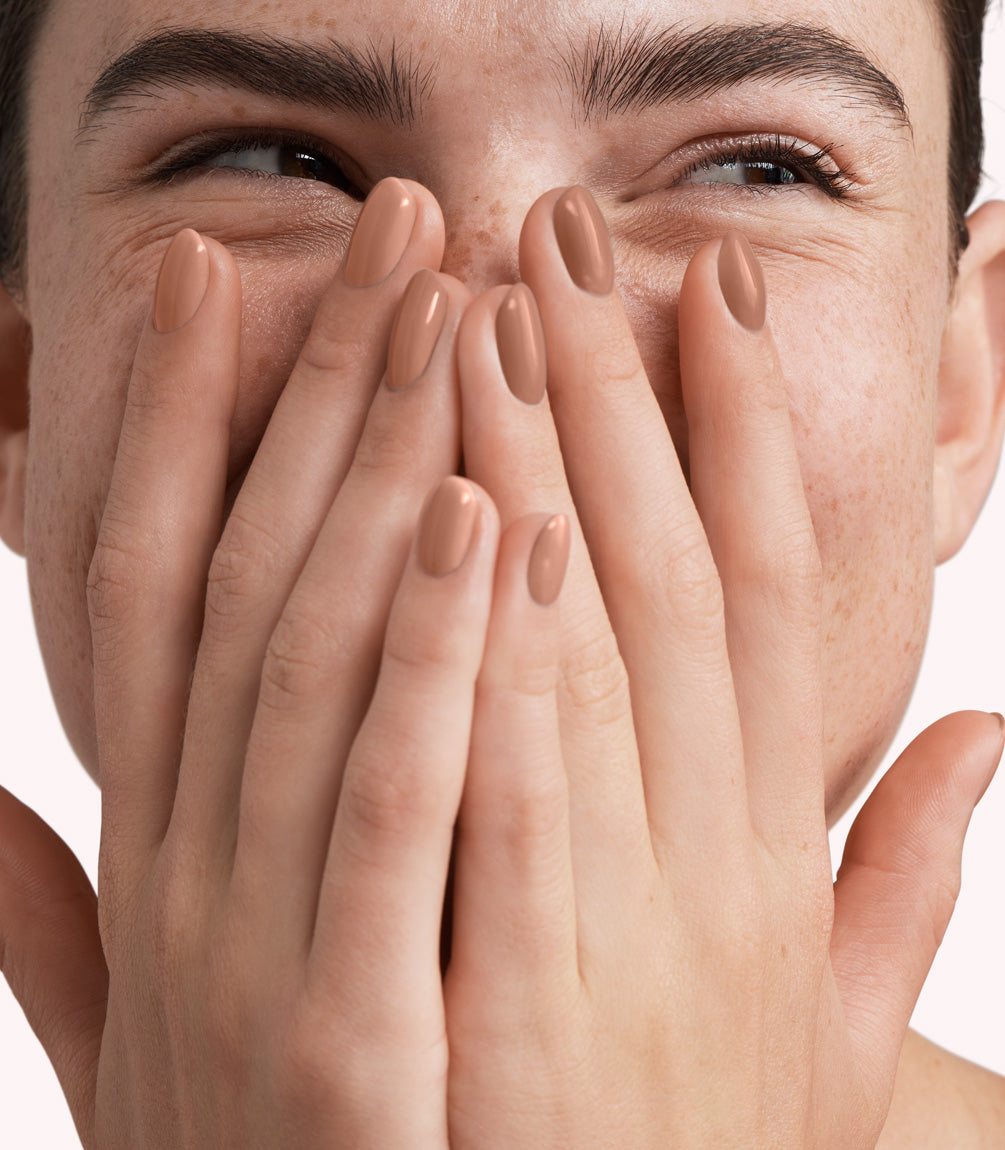 Close-up of a woman with Pink Gellac 330 Caramel Beige manicured nails near her face.