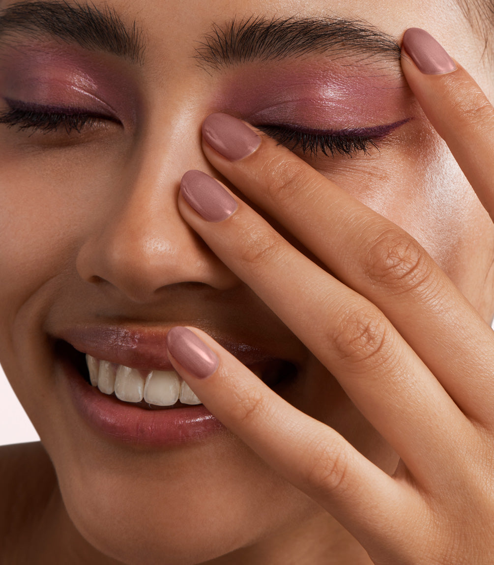Close-up of a woman with Pink Gellac 363 Dazzling Mauve manicured nails near her face.