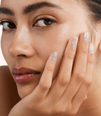 Close-up of a woman with Pink Gellac 382 Shining Star manicured nails near her face.