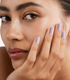 Close-up of a woman with Pink Gellac 392 Misty Lilac manicured nails near her face.