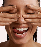 Close-up of a woman with Pink Gellac 432 Shimmering Spice manicured nails near her face.