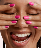Close-up of a woman with Pink Gellac 435 Premium Pink manicured nails near her face.