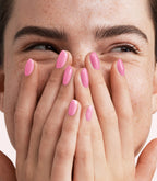 Close-up of a woman with Pink Gellac 457 Hibiscus Pink manicured nails near her face.