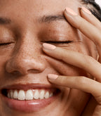Close-up of a woman with Pink Gellac 464 Pink Feather manicured nails near her face.