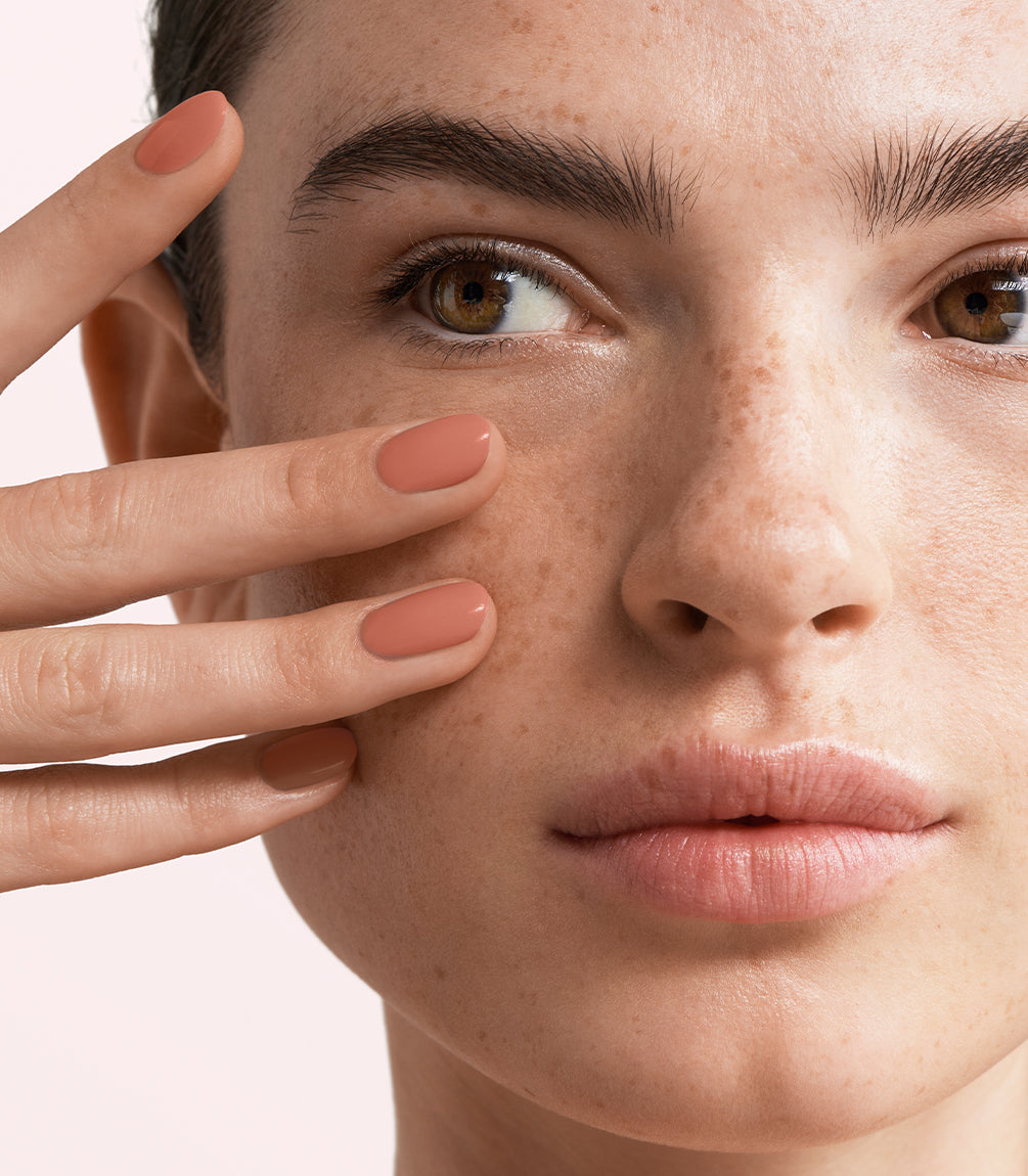 Close-up of a woman with Pink Gellac 465 Strawberry Soufflé manicured nails near her face.