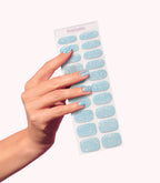 Hand wearing Pink Gellac 009 Holographic Blue gel nail stickers.