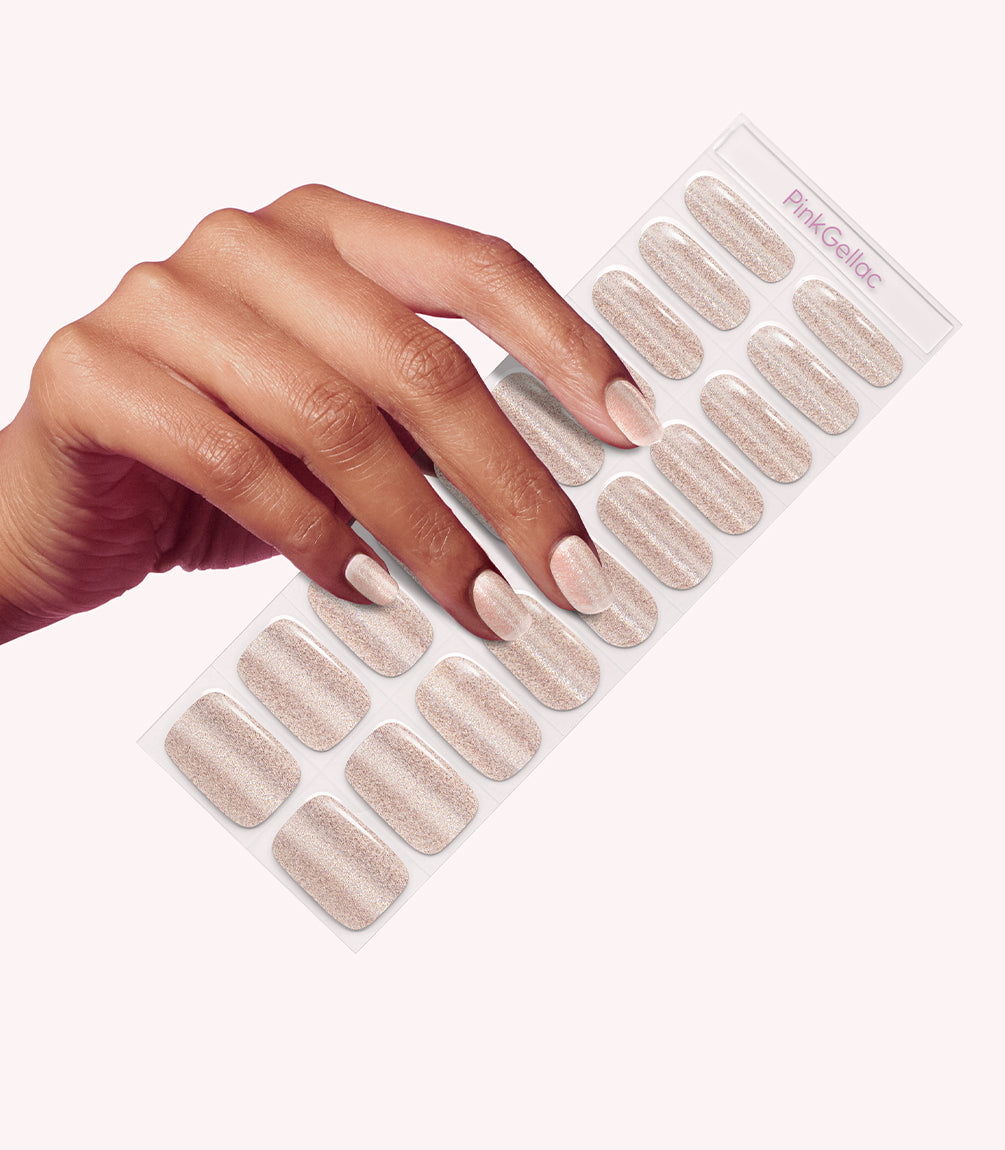 Hand wearing Pink Gellac 025 Cat Eye Champagne Gold gel nail stickers.