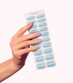 Hand wearing Pink Gellac 026 Cat Eye Misty Blue gel nail stickers.