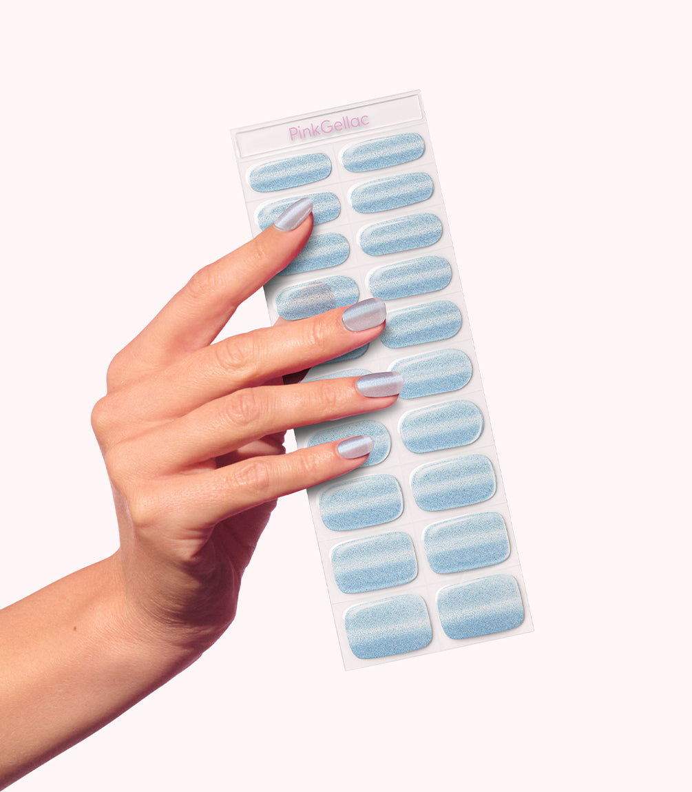 Hand wearing Pink Gellac 026 Cat Eye Misty Blue gel nail stickers.